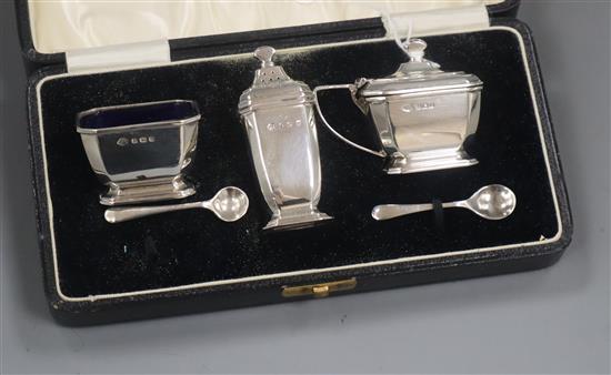 A 1930s cased three piece silver condiment set, with two spoons, by Adie Brothers.